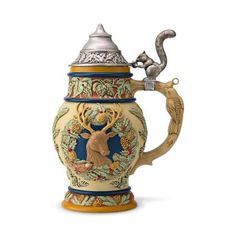 an ornately decorated beer mug with a deer head on the front and bottom part