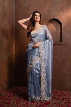 Indulge in the pure luxury of our Hand Embroidered Blue Tissue Organza Saree. Each thread is carefully and meticulously embroidered by hand, creating a one-of-a-kind piece that exudes elegance and sophistication. Elevate your style and make a statement with this exclusive saree. SKU: 0005 Sarees Indian Classy, Hand Work Saree Design, Flowy Saree, Karwa Chauth Look, Organza Saree Blouse Designs Latest, Catalogue Photoshoot, Organza Saree Blouse Designs, Tissue Organza Saree, Female Elegance