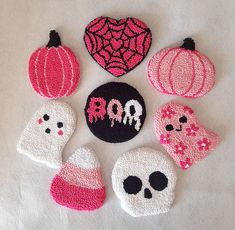 six embroidered halloween appliques arranged in the shape of skulls, pumpkins and hearts