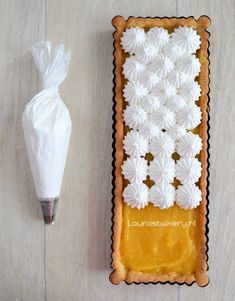 a pastry with white icing on it next to an object that looks like flowers