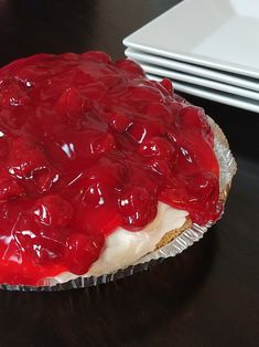 a pie with cherries on it sitting on a table