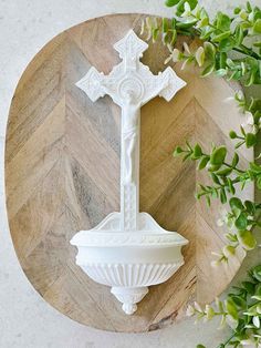 a white cross on top of a wooden board