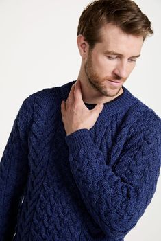 Our Omey Aran Crew Neck unisex Sweater is the perfect balance of the old and the new. The use of the traditional Aran moss and cable stitch allows us to celebrate and honour the beauty of Irish heritage as the crew neck cut finds its place in the modern wardrobe with ease. The Omey Aran Crew Neck Sweater has been thoughtfully crafted with our signature Supersoft Merino wool. The Supersoft Merino wool makes for an incredibly gentle, warm and cosy feel, making the Omey Aran Crew Neck the perfect blend of comfort and luxury. This unisex sweater truly celebrates Ireland’s treasures. Model Wears: Male Height: 6ft 2inches Wearing: M Aran Blanket, Aran Hat, Aran Cardigan, Aran Sweater, Winter Fit, Cashmere Beanie, Irish Heritage, Shetland Wool, Cable Stitch