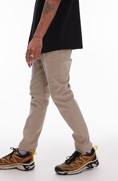 A skinny fit lends contemporary appeal to classically styled twill chinos made with a hint of easy-moving stretch. Zip fly with button closure Side-seam pockets; back button-welt pockets 97% cotton, 3% elastane Machine wash, line dry Imported Casual Slim Workwear Pants, Casual Slim Work Pants, Business Casual Tapered Leg Chino Jeans, Fitted Slim Cotton Pants, Slim Cotton Pants With Pockets, Fitted Chinos With Hip Pockets For Fall, Fitted Chinos For Fall, Fitted Pants With Five Pockets For Everyday, Slim Fit Flat Front Chinos With Pockets