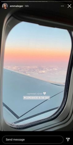 an airplane window looking out at the sky and clouds with text that reads, somewhere in the sky