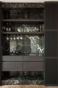 an elegant black and white display case with wine glasses