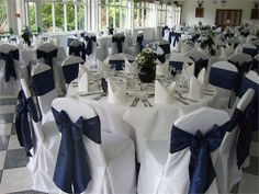 the tables are set up with white and blue cloths for an elegant wedding reception