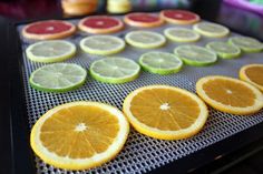 oranges, lemons and limes are on a baking sheet in preparation to be cooked