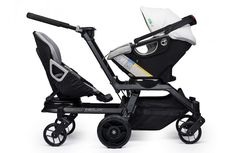 the stroller is black and has two seats on each side, with one seat folded open