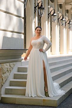 a woman in a white dress standing on some steps