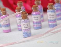 small bottles filled with tiny pink and blue flecks