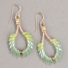 two pairs of earrings with green and white beads on them, hanging from gold - plated hooks