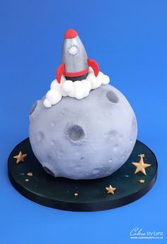 a cake made to look like the moon with a santa hat on it's top