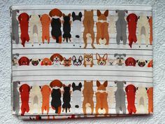 an orange and white bag with dogs on it's side, hanging from a wall