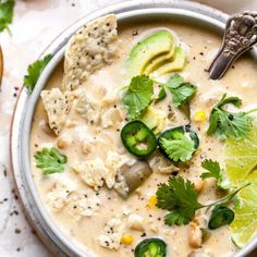 a bowl filled with soup and topped with avocado