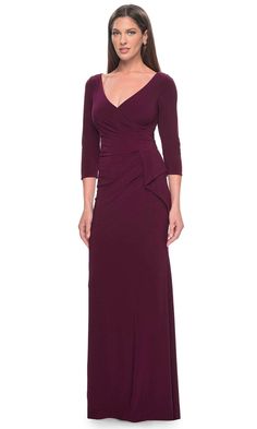 Indulge in sophistication with the La Femme 30967 gown, expertly tailored from opulent jersey fabric. Long sleeves provide a touch of modesty, harmonizing with the faux-wrap bodice that frames a refined V-neckline. Meticulous ruching accentuates the feminine silhouette, ensuring an elegant and flattering look. The semi-full back, adorned with a discreet concealed zipper closure, guarantees a smooth and seamless fit. A subtle ruffle accent graces the sheath skirt, cascading with grace to a floor- Fitted Long Sleeve Pre-draped Evening Dress, Elegant V-neck Gown With Ruched Bodice, Fitted Floor-length Elastane Dress, Elegant Long Sleeve Ruched Evening Dress, Elegant Fitted Draped Evening Dress, Elegant Mother Of The Bride Dress With Ruched Bodice, Long Sleeve Ruched Evening Dress For Formal Occasions, Fitted Pre-draped Evening Dress With Pleated Bodice, Fitted Draped Evening Dress For Gala