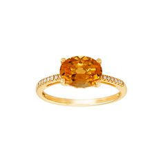 Rock this chic ring featuring a November birthstone stone. Crafted in 10K yellow gold, this ring features a 9 by 7 mm natural oval-cut citrine center stone with round-cut diamond accent stones on the shoulders. Wear this versatile ring on its own or stack it with other pieces for a layered look. Gender: female.  Age Group: adult. Chic Rings, Ring With Diamond, Citrine Ring, November Birthstone, Layered Look, Round Cut Diamond, Oval Cut, Citrine, Women Rings