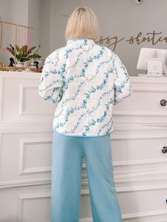 Wrap yourself in floral perfection with the Blue Floral Crest Quilted Jacket from Sassy Shortcake. This ivory, quilted jacket features a playful blue floral pattern and side pockets, all finished off with a blue lined hem. Stay warm and stylish in this fun jacket. content: 100% nylon care: hand wash cold fits true to size, model wearing size small Blue Floral Print Cotton Outerwear, Blue Cotton Floral Print Outerwear, Spring Floral Print Outerwear For Loungewear, Blue Outerwear For Spring Loungewear, Sassy Shortcake, Fun Jacket, Patriotic Dresses, Cold Fits, Blue Floral Pattern