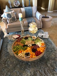 a glass table topped with lots of fruit and veggies on top of it