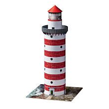 a red and white lighthouse on top of a piece of paper that is cut out