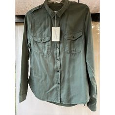 This Olive Green Nwt University Threads Shoulder Tab Shirt Top Is An Excellent Addition To Any Woman's Wardrobe. The Shirt Is Made From Soft And Comfortable Lyocell Material, Which Feels Great On The Skin. The Long-Sleeved, Button-Up Design Is Perfect For A Casual Day Out Or A Night On The Town. The Shirt Is Available In Size Small And Is A Regular Fit For Women. The Solid Pattern And Collared Neckline Make It A Versatile Piece That Can Be Dressed Up Or Down. The Shirt Is Perfect For Anyone Who Green Tops With Pockets, Casual Khaki Cotton Blouse, Solid Pattern, Women's Wardrobe, Universal Thread, Shirt Top, Olive Green, Top Shirt, Button Up