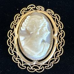 This vintage brooch and pendant combo is a unique addition to any jewelry collection. The intricate filigree design is made of 12k yellow gold filled metal, and features a beautiful oval-shaped shell cameo as the main stone. This piece is signed and comes from Italy, adding to its rarity. Perfect for those who appreciate fine jewelry, this brooch pendant can be worn on a variety of occasions. Its vintage charm and delicate details are sure to catch the eye of anyone who sees it. Add it to your c Carved Gold Brooch For Gift, Carved Gold Brooches For Gift, Carved Gold Brooches As Gifts, Elegant Carved Gold Brooches, Ornate Carved Gold Brooches, Ornate Gold Carved Brooches, Heirloom Filigree Oval Brooch, Heirloom Style Oval Filigree Brooch, Heirloom Oval Filigree Brooch