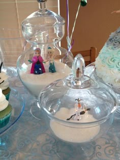 some cupcakes and cakes on a table with frosting in the shape of snowmen