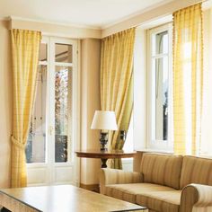 a living room with two couches and a coffee table in front of the window