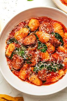 a white bowl filled with pasta and sauce