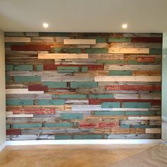 a wall made out of wooden planks in an empty room with no one on the floor