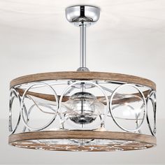 a wooden and glass light fixture hanging from the ceiling