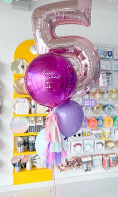 the number five balloon is purple and pink