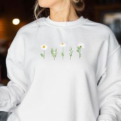 🌸 Blossom in Style! Embrace the beauty of nature every day with our stunning Embroidered Daisy Sweatshirt. Ideal for any nature lover or plant lady, this sweatshirt is more than just clothing--it's a celebration of your love for all things floral and vintage. 🎁 A Gift That Blooms All Year Round: Whether you're shopping for Mother's Day, birthdays, or just because, this beautifully embroidered floral sweatshirt is the perfect gift for her. Delight the nature enthusiast in your life with a styli Daisy Sweatshirt, Nature Enthusiast, Floral Sweatshirt, Flower Sweatshirt, Plant Lady, Vintage Inspired Design, Gifts For Nature Lovers, Perfect Gift For Her, Floral Designs