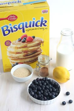 blueberries, lemons, and other ingredients are on the table next to a carton of bisquick