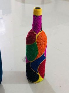 a bottle made out of yarn and beads