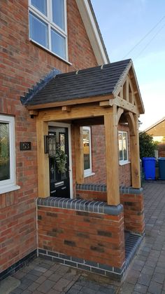 a brick house with a black door and window