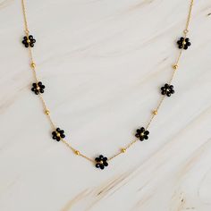 Experience the whimsical charm of our Flower Field Romance Beaded Necklace. Adorned with beautifully colored flowers, and a dainty chain that is perfect for layering and adding a touch of romance to any outfit. Dimensions: approximately 15" with a 2" extender 18k gold plated stainless steel with water and tarnish resistant finish Lead and Nickel free Crafted in China Adjustable Delicate Flower Necklace With Delicate Chain, Delicate Adjustable Flower Necklace With Delicate Chain, Gold Flower Necklace With Beaded Chain, Gold Flower Shaped Necklace With Beaded Chain, Delicate Flower Shaped Jewelry With Tiny Beads, Dainty Flower Necklace With Tiny Beads, Dainty Flower Shaped Jewelry With Tiny Beads, Dainty Flower Jewelry With Tiny Beads, Delicate Beaded Flower Necklace