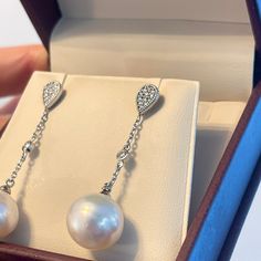 14KT white gold Paspaley South Sea pearl + pave diamond drop dangle earrings. Length: 28mm Width: 11mm pearl 11mm Paspaley Pearls; "Circle" shape; "Fine" quality Paspaley Certificate of Authenticity included Made to order: please allow 1-2 weeks prior to shipping 14K push backs .25 Carat total weight diamonds Luxury Pearl Dangle Earrings With Diamond Accents, Luxury Diamond White Dangle Pearl Earrings, White Pearl Earrings With Pave Setting, Fine Jewelry Diamond Dangle Pearl Earrings, White Gold Dangle Pearl Earrings Fine Jewelry, White Gold Dangle Pearl Earrings, Elegant White Pearl Earrings With Pave Setting, Diamond White Dangle Pearl Earrings With Diamond Accents, Diamond Dangle Pearl Earrings As Gift