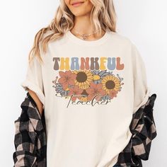 Celebrate the season of gratitude with our Thankful Teacher t-shirt, featuring a beautiful fall floral design! This cozy and stylish tee is perfect for teachers who love autumn and want to share their appreciation for the students and moments that make teaching special.  Sizing: .: Refer to size chart in the photos. .: Women, for a fitted look order a size down from your normal size selection. These shirts have unisex fit so your regular size will be looser than normal.  .: To ensure a great fit measure your current favorite t-shirt and compare it to the size chart.  How To Order: .: Use the pull-down menus to select your shirt color and size. .: If you are ordering more than one shirt, add all the sizes separately to the chart and then submit your order.  About The Shirt: .: Comfort Color Cute Fall Teacher Shirts, Season Of Gratitude, Love Autumn, Fall Florals, Thanksgiving Shirt, Teacher Tees, Gift Teacher, Thanksgiving Shirts, Comfort Color