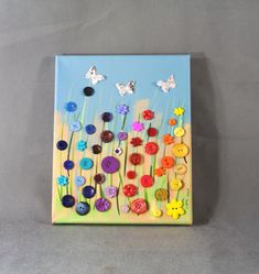 a painting with buttons and butterflies on it