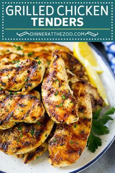 grilled chicken tenders on a plate with lemon wedges