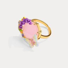 Indulge in the magical beauty of our Pink Crystal Lavender Butterfly Ring. With a stunning pink crystal at its center, surrounded by delicate lavender accents and butterfly motifs, this ring exudes love, romance, and an energy of tranquility. Dressing up your hand with such a bright and colorful floral ring will easily bring joy and energy to your look. Let it inspire you and add a touch of enchantment to any outfit. DETAILS Plating: 18K Gold Materials: 18K Gold on Brass, Enamel, Gemstones, Pear Luxury Lavender Rings For Gift, Pink Flower Ring For Spring Wedding, Pink Spring Anniversary Jewelry, Spring Wedding Pink Flower Ring, Pink Fine Jewelry Butterfly Ring As Gift, Elegant Spring Jewelry With Butterfly Charm, Elegant Pink Butterfly Ring, Elegant Spring Butterfly Jewelry, Pink Butterfly Ring For Wedding