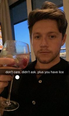 a man holding up a wine glass in front of his face with the words don't care, didn't ask, plus you have ice