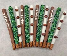 football themed pretzels are arranged in the shape of sticks with grass on them