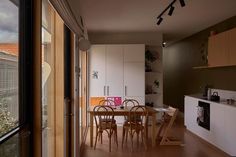 an open kitchen and dining area with sliding glass doors