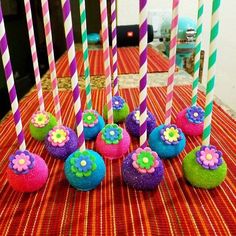 there are many colorful candles on the table with straws in front of them,