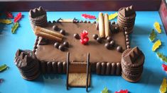 a cake made to look like a castle with chocolate frosting and decorations on it