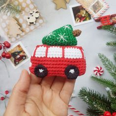 a hand holding a small crocheted christmas ornament with a tree on top