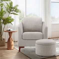 a living room with a chair, ottoman and potted plant