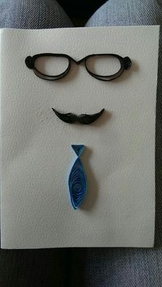 a piece of paper that looks like a man's face with glasses and a tie